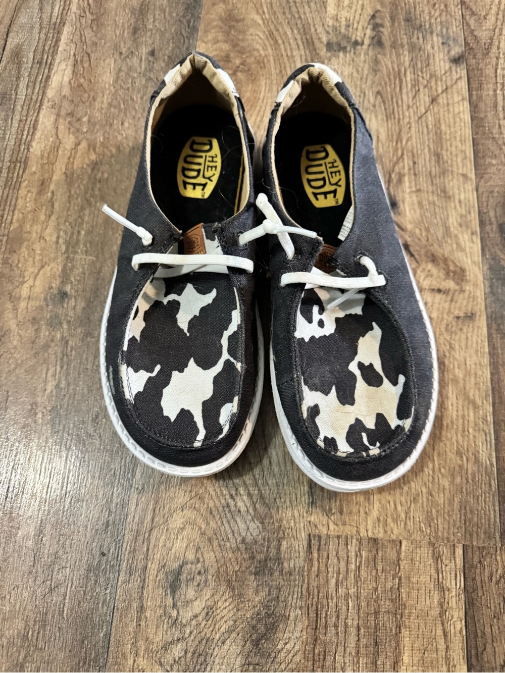 Hey Dude Kids Black and White Cow Pattern Slip-On Sneakers